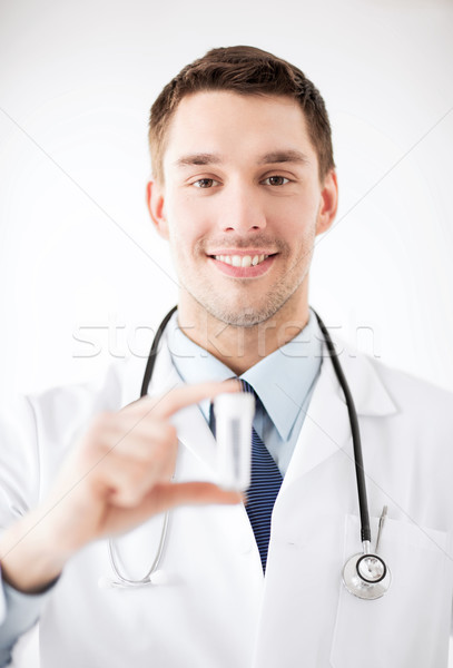 young male doctor with empty test-tube Stock photo © dolgachov