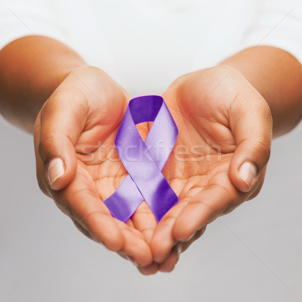 hands holding purple awareness ribbon Stock photo © dolgachov