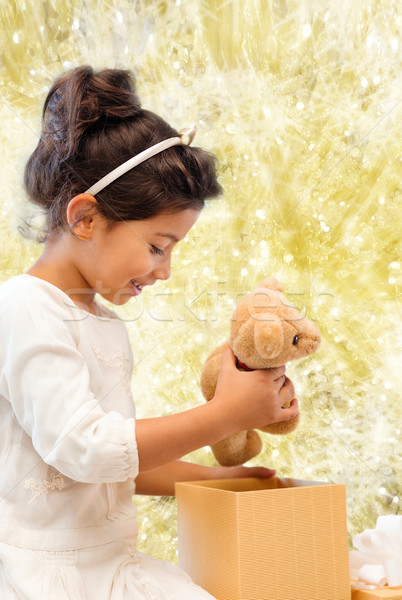 smiling little girl with gift box Stock photo © dolgachov