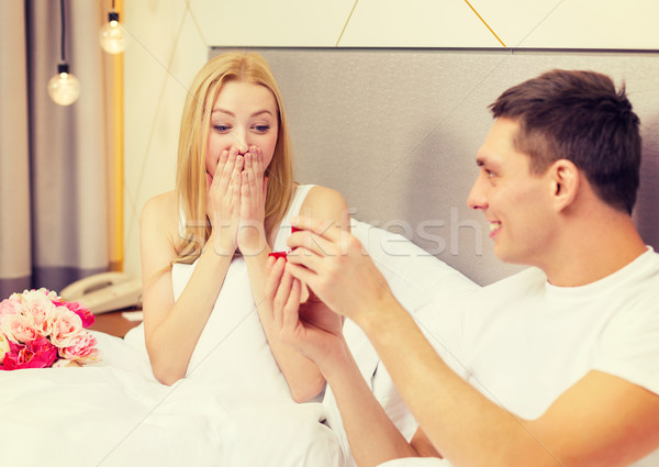 man giving woman little red box and ring in it Stock photo © dolgachov