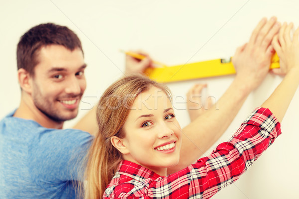 couple building using spirit level to measure Stock photo © dolgachov