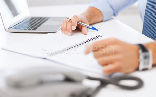 businessman writing in notebook Stock photo © dolgachov