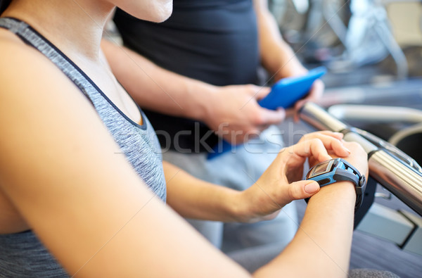 close up of woman setting heart-rate watch at gym Stock photo © dolgachov