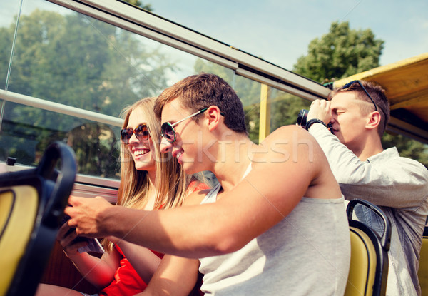 smiling couple with book traveling by tour bus Stock photo © dolgachov