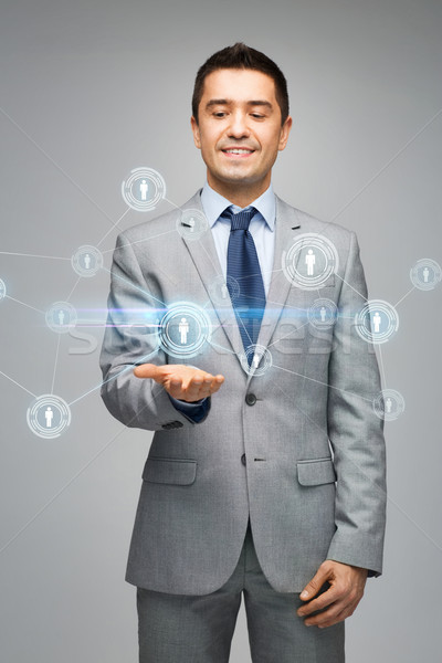 happy businessman in suit showing network contacts Stock photo © dolgachov