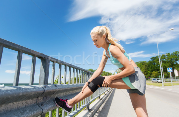 young woman with injured knee or leg outdoors Stock photo © dolgachov