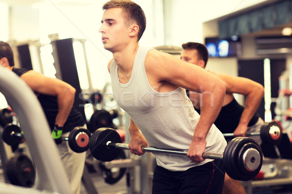 group of men with barbells in gym Stock photo © dolgachov