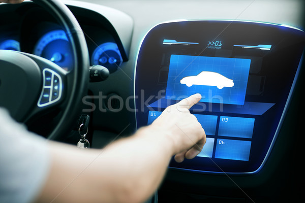 Stock photo: male hand pointing finger to car icon on panel