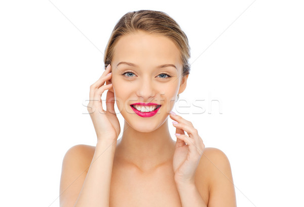 smiling young woman with pink lipstick on lips Stock photo © dolgachov