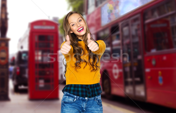 happy young woman or teen girl showing thumbs up Stock photo © dolgachov