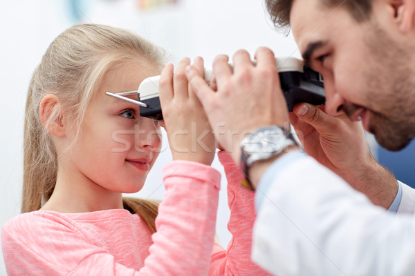 optician with pupilometer and patient Stock photo © dolgachov