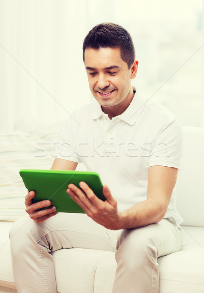 smiling man working with tablet pc at home Stock photo © dolgachov