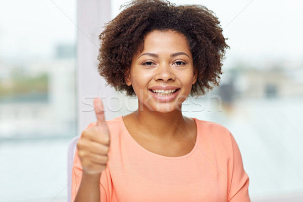 Stock photo: happy african young woman showing thumbs up