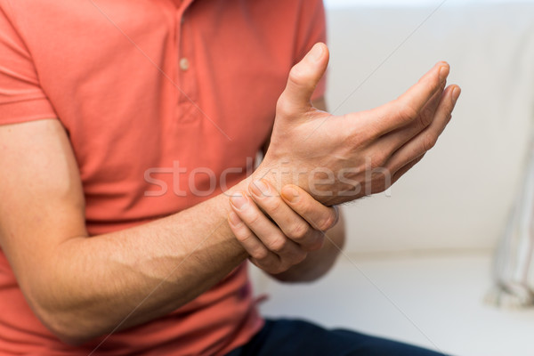 close up of man with  pain in hand at home Stock photo © dolgachov