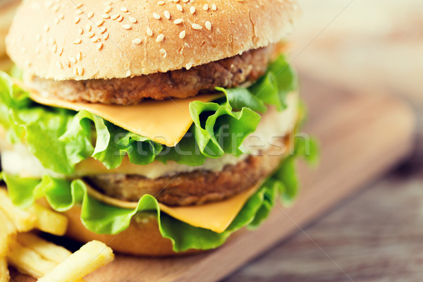 close up of hamburger or cheeseburger on table Stock photo © dolgachov