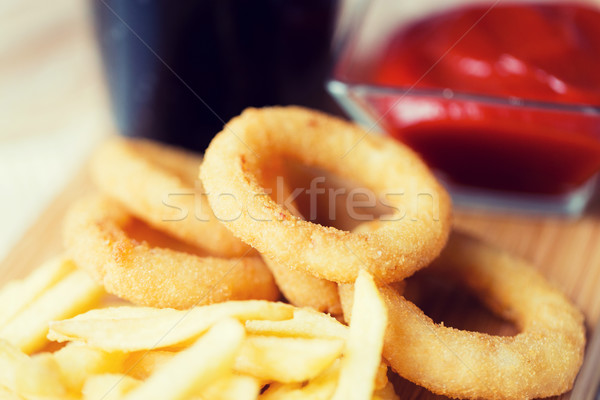 close up of fast food snacks and drink on table Stock photo © dolgachov