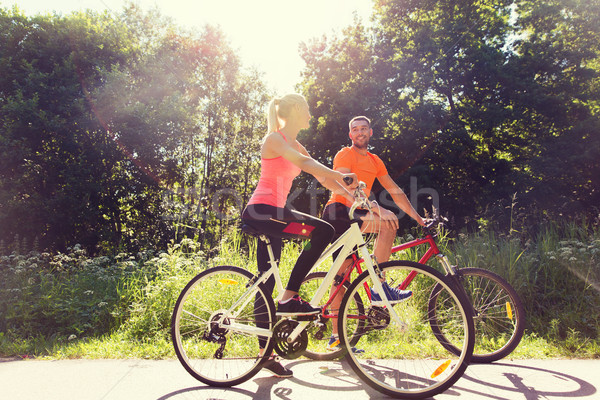 Stock photo: happy couple riding bicycle outdoors