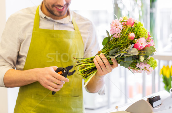 close up of florist man with flowers and pruner Stock photo © dolgachov