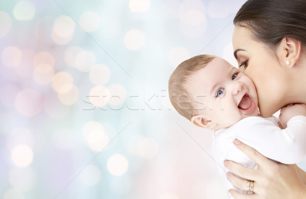 happy mother kissing adorable baby Stock photo © dolgachov