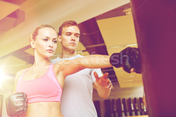woman with personal trainer boxing in gym Stock photo © dolgachov