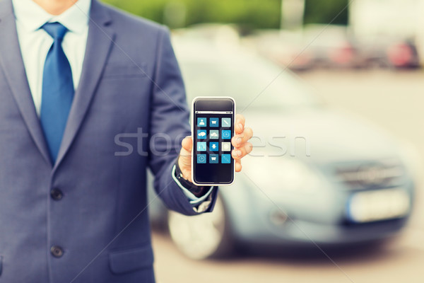 Stock photo: close up of business man with smartphone menu