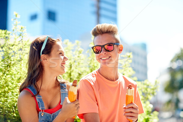 happy teenage couple eating hot dogs in city Stock photo © dolgachov