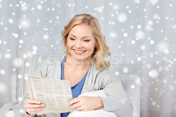 smiling woman reading newspaper at home Stock photo © dolgachov