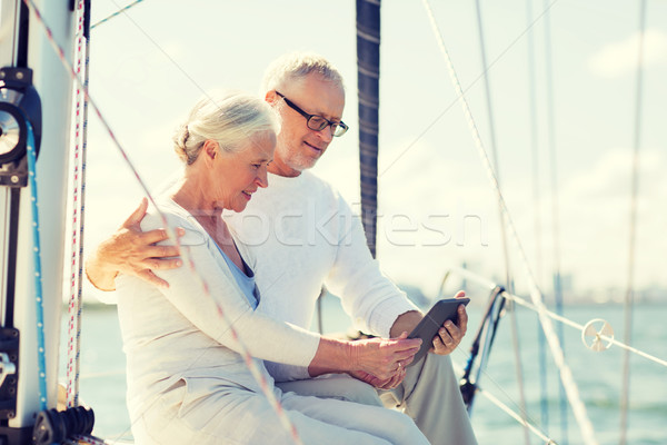 senior couple with tablet pc on sail boat or yacht Stock photo © dolgachov