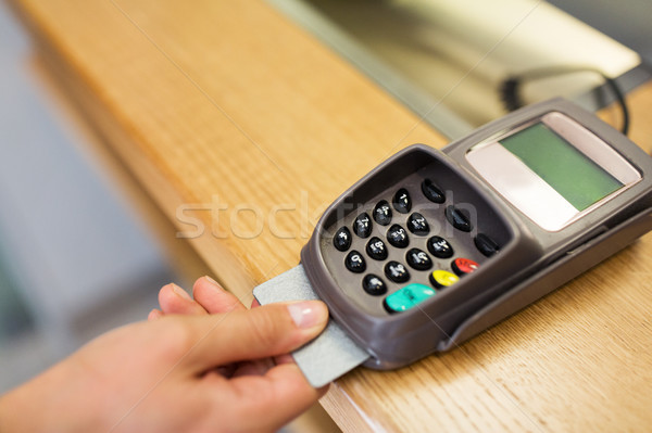 Stock photo: close up of hand inserting bank card to terminal