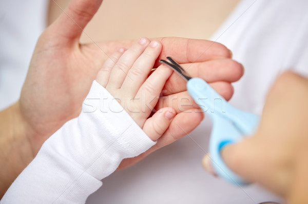 close up of hand with scissors trimming baby nails Stock photo © dolgachov