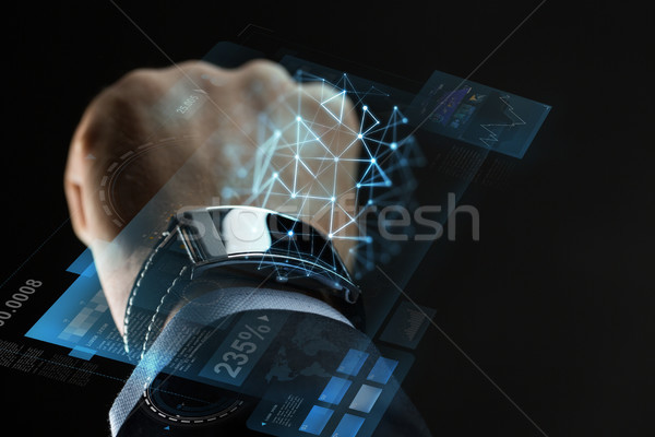close up of businessman hand with smartwatch Stock photo © dolgachov
