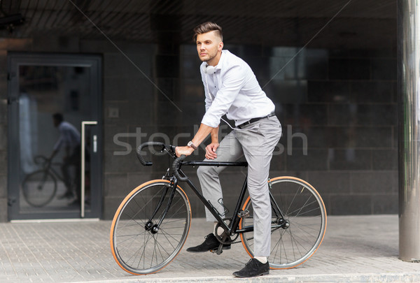 Stock photo: man with bicycle and headphones on city street