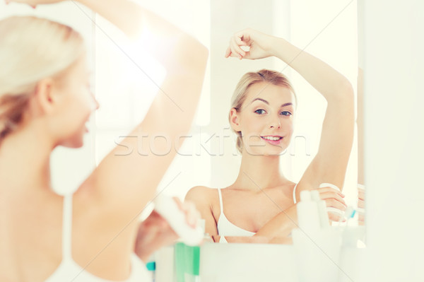 woman with antiperspirant deodorant at bathroom Stock photo © dolgachov