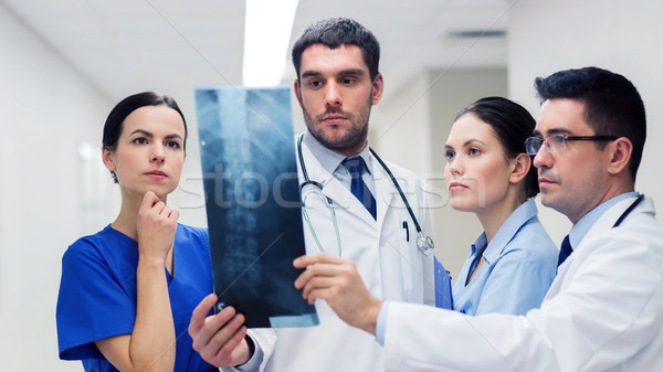 group of medics with spine x-ray scan at hospital Stock photo © dolgachov