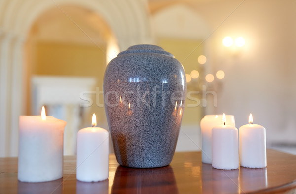 cremation urn and candles burning in church Stock photo © dolgachov