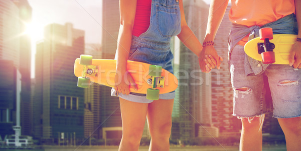 close up of young couple with skateboards in city Stock photo © dolgachov