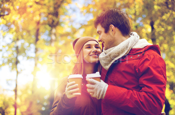 Stock photo: happy couple with coffee walking in autumn park