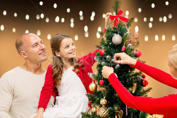 happy family decorating christmas tree at home Stock photo © dolgachov