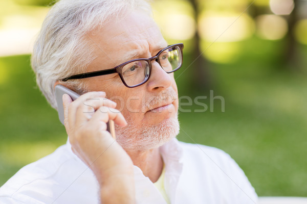 sad senior man in glasses calling on smartphone Stock photo © dolgachov