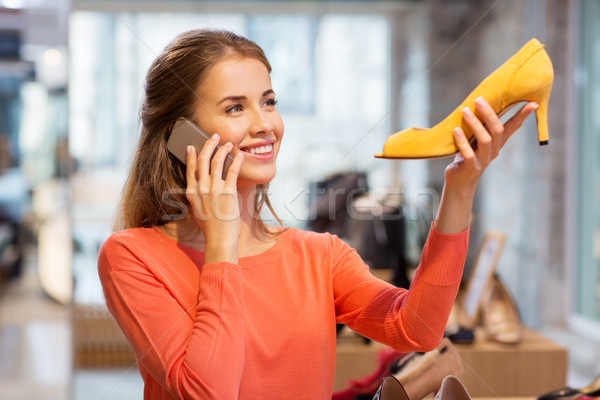 young woman calling on smartphone at shoe store Stock photo © dolgachov