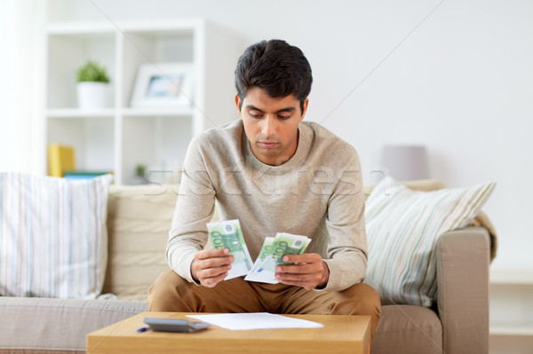 man counting money at home Stock photo © dolgachov