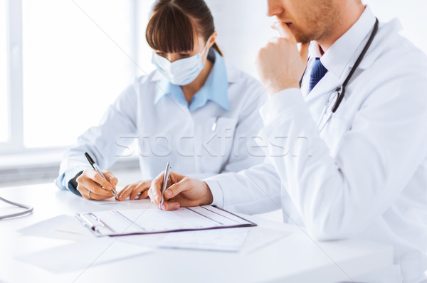 doctor and nurse writing prescription paper Stock photo © dolgachov