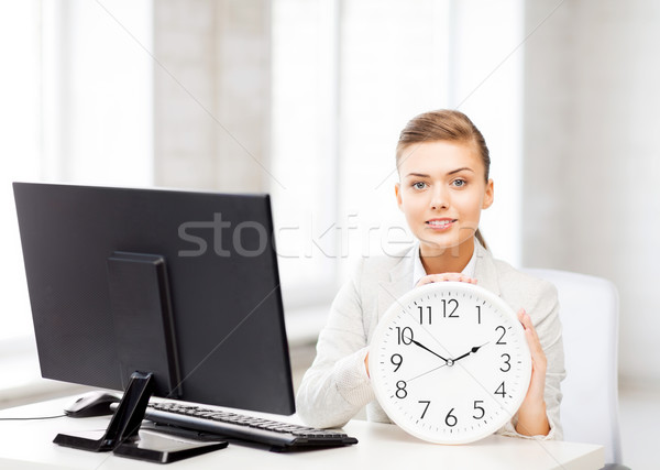 attractive businesswoman with white clock Stock photo © dolgachov