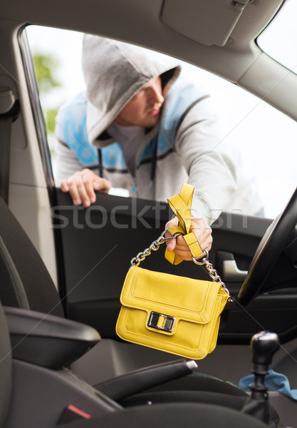 thief stealing bag from the car Stock photo © dolgachov