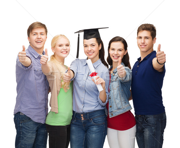 group of students with diploma showing thumbs up Stock photo © dolgachov
