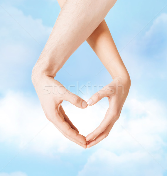 woman and man hands showing heart shape Stock photo © dolgachov