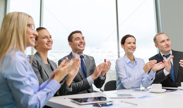 business team with laptop clapping hands Stock photo © dolgachov