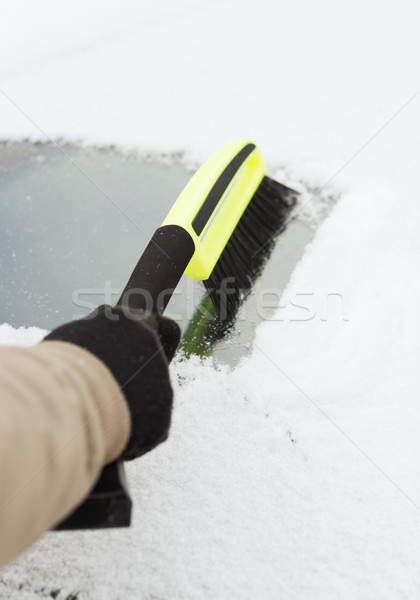 closeup of man cleaning snow from car Stock photo © dolgachov