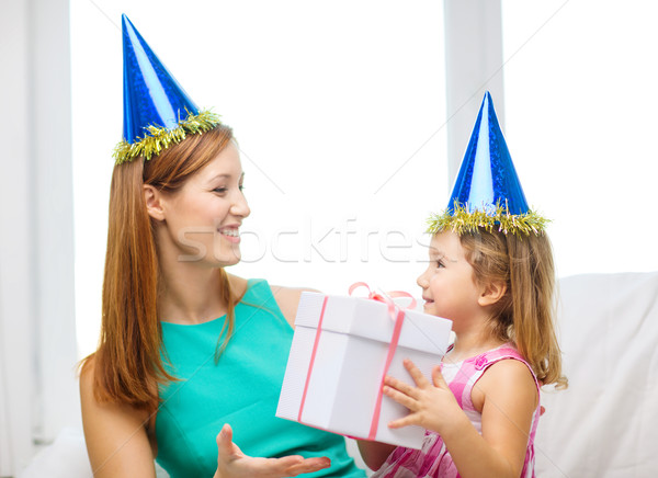 Stock photo: mother and daughter in blue hats with favor horns