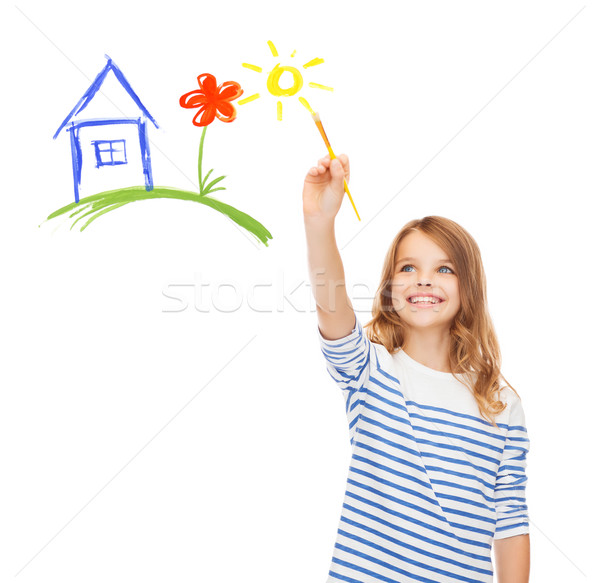 cute little girl drawing house with brush Stock photo © dolgachov